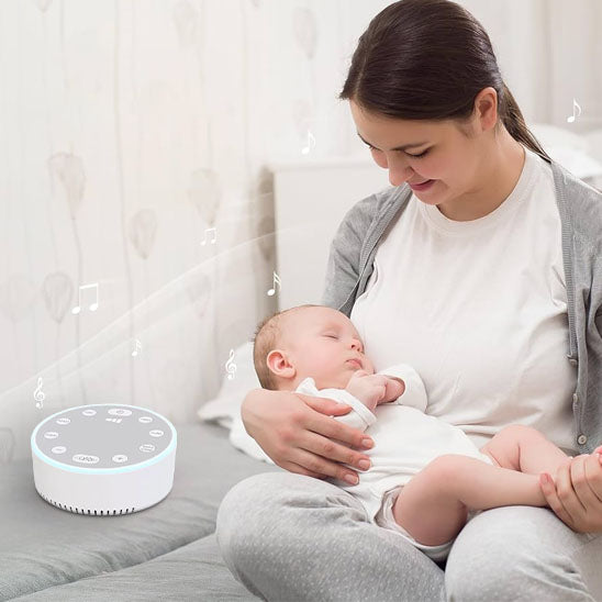 Veilleuse bruit blanc bébé dans les bras
